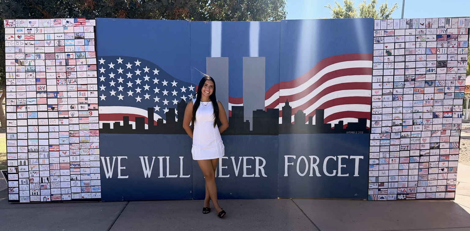 Aiyana Castro standing before the completed Las Vegas youth-created 9/11 Remembrance Wall