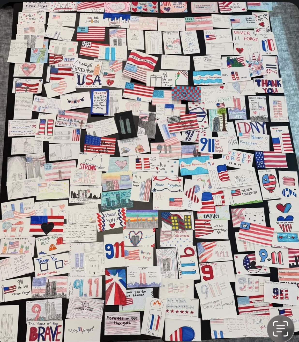 Youth created cards reading Never Forget, We Remember, and Thank You