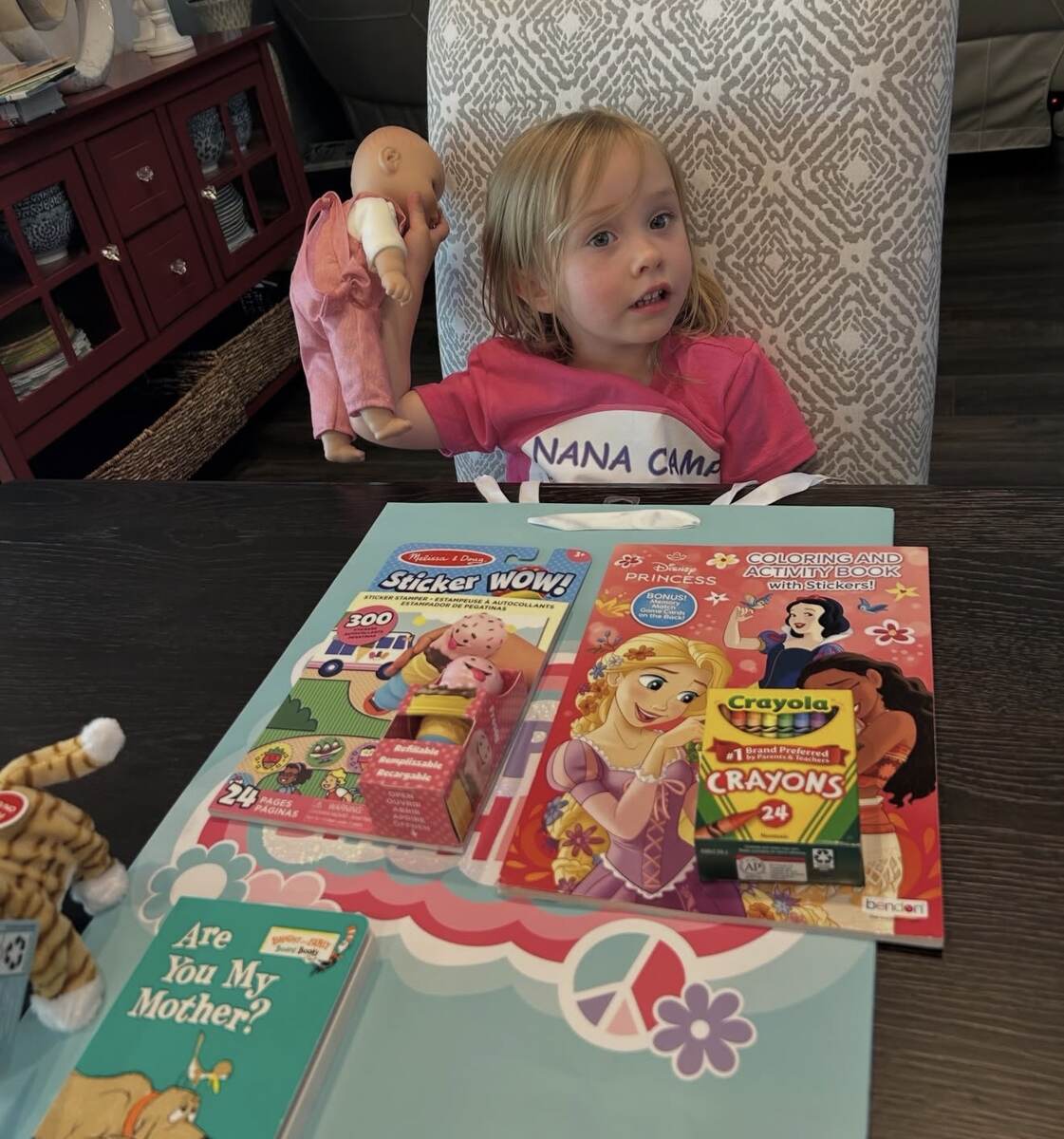 Young child enjoying books from a personalized birthday bag