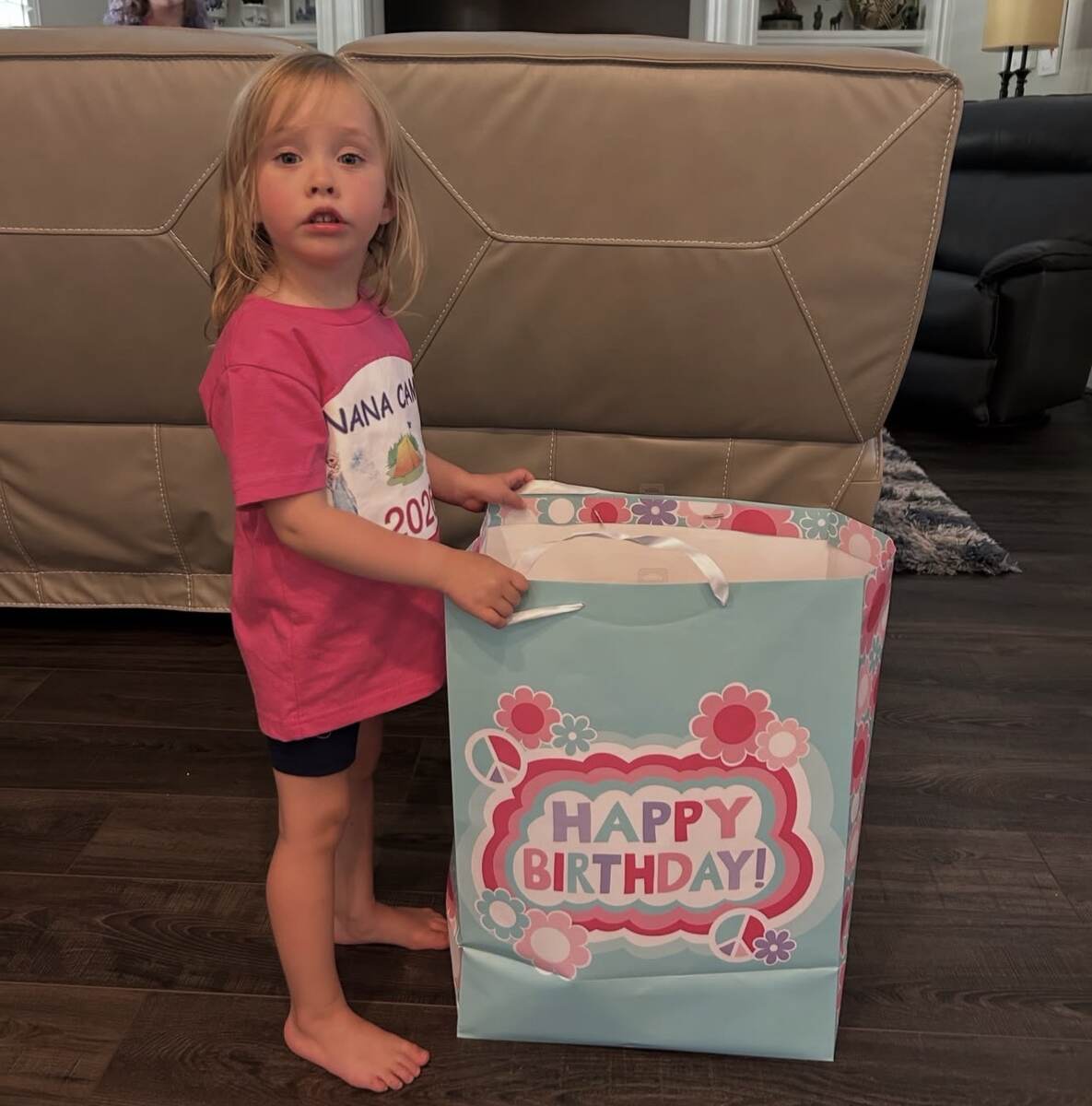 Young child receiving a decorated hospice birthday box