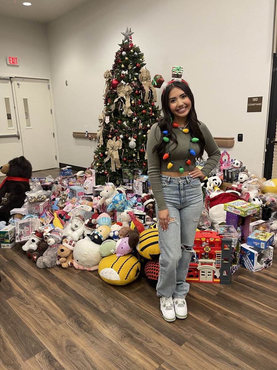 Aiyana beside the Hospice Christmas Blessing gifts