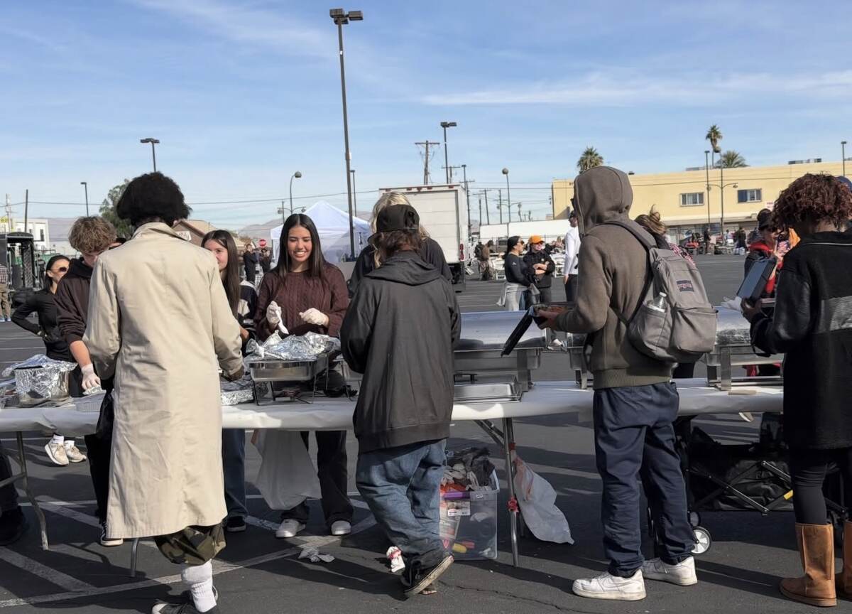 Youth volunteers serving hot Thanksgiving meals to community members