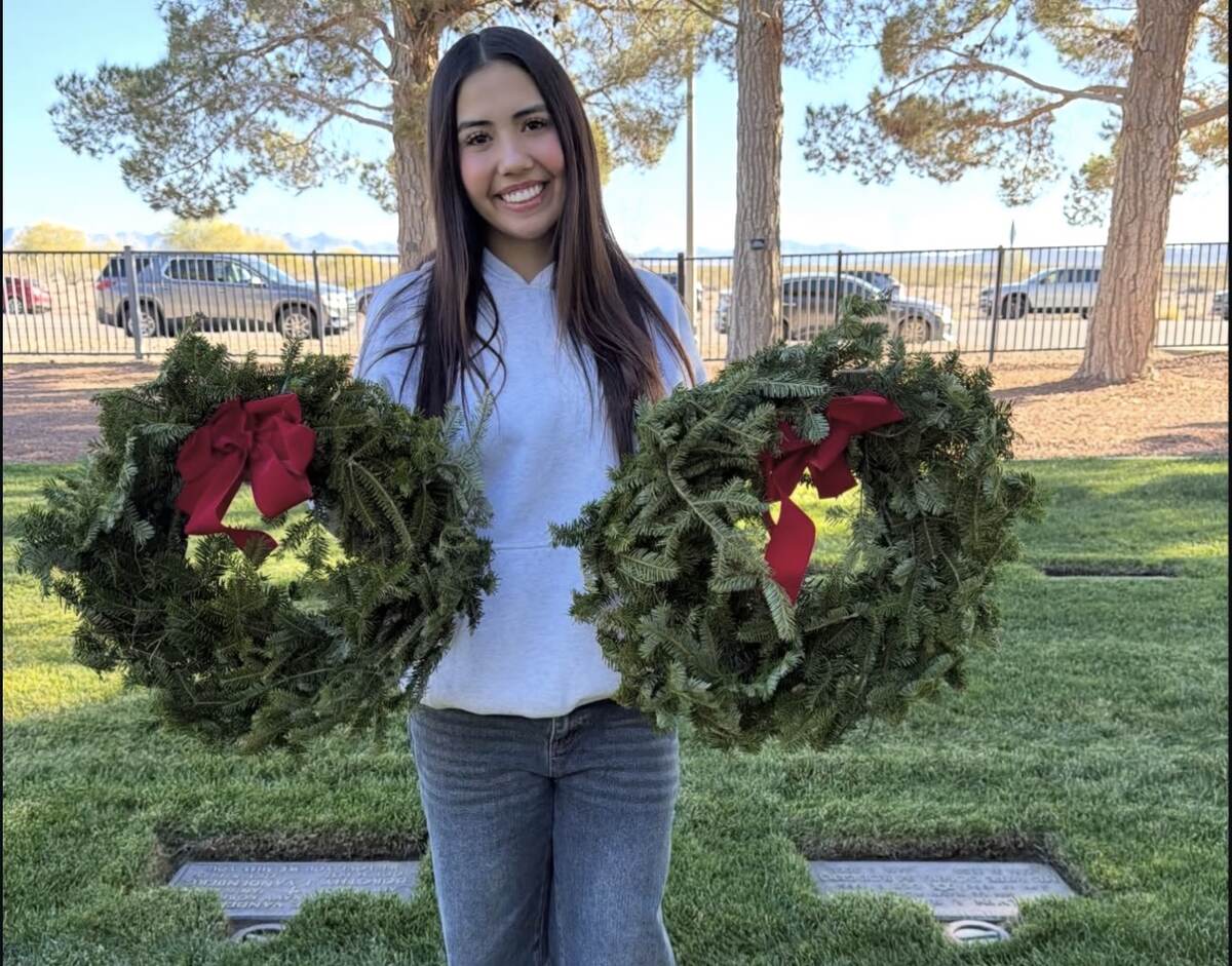 Aiyana holding memorial wreaths at the Southern Nevada Veterans Memorial Cemetery