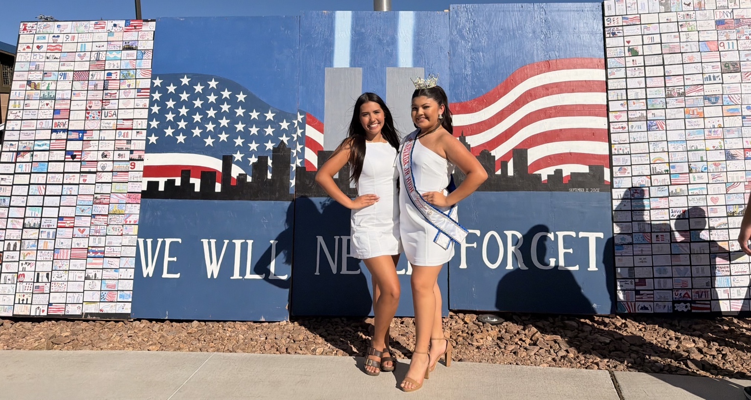 Aiyana Castro and a community honoree beside the 9/11 Remembrance Wall at Desert Breeze Ballfields