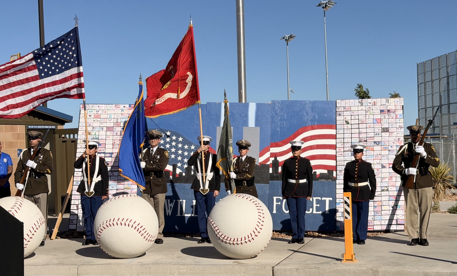 Color Guard standing before Aiyana Castro’s youth-created 9/11 Remembrance Wall at the Great American Kickoff
